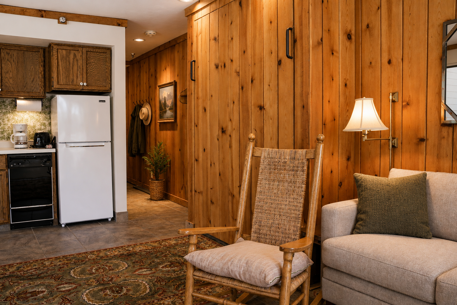 Cozy mountain living room with a stone fireplace, comfy sofa, and balcony access.