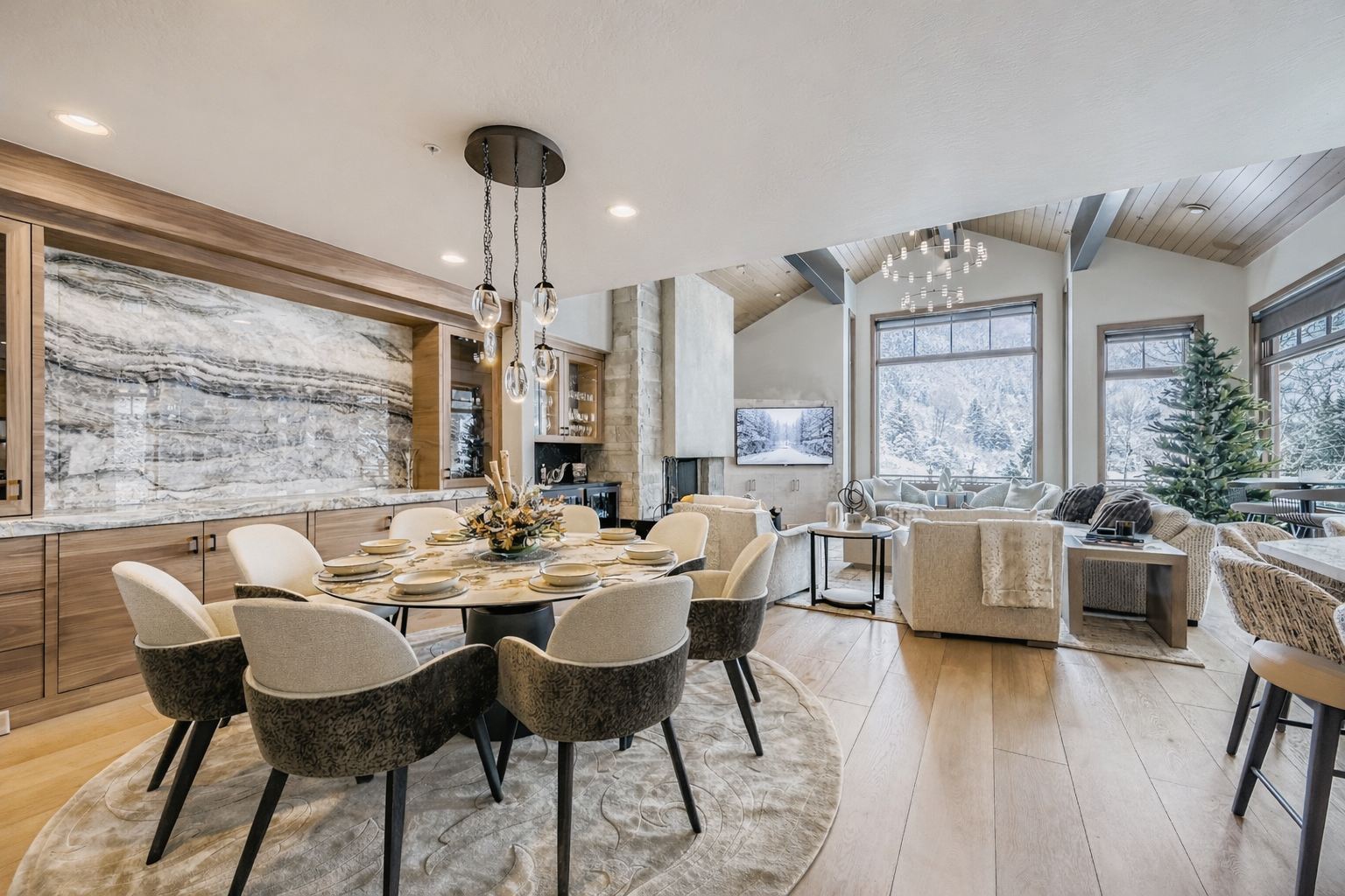 Your elegant dining space features a stunning round table with contemporary seating, complemented by warm wood finishes and modern architectural details throughout.