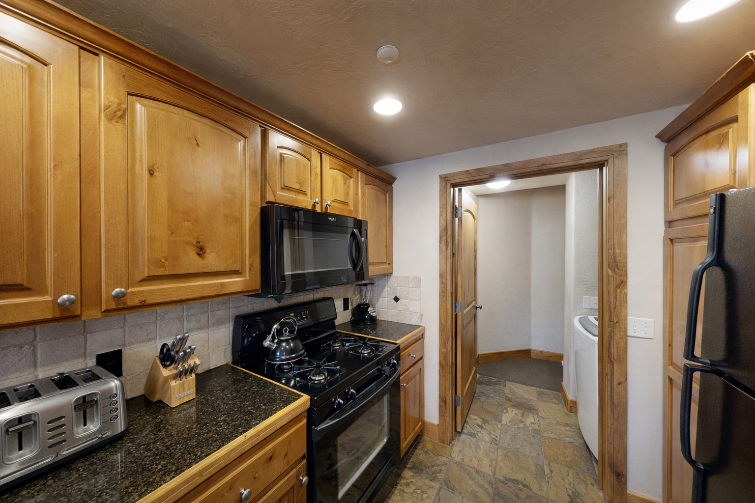 Your fully equipped kitchen features granite counters, stainless appliances, and warm wood cabinets for memorable meal preparation.