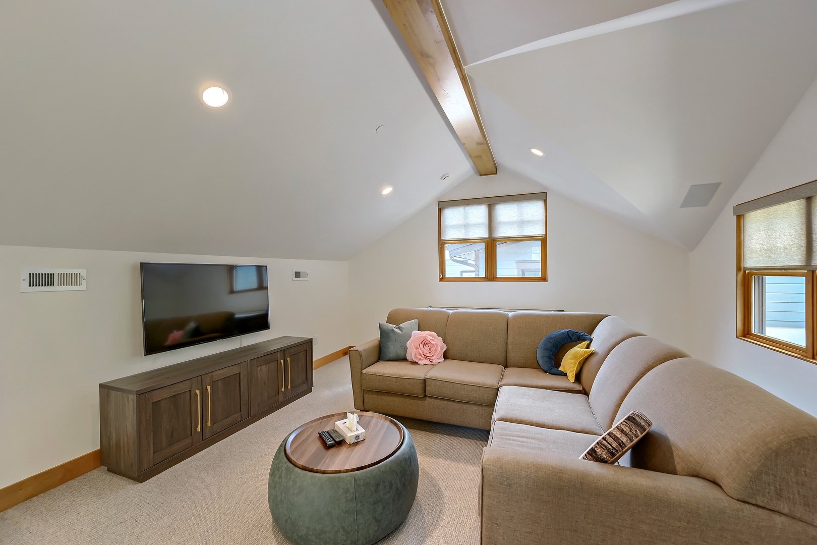 Curl up in your private loft lounge with soaring vaulted ceilings, warm wood beams, and soft natural light perfect for relaxing with loved ones.