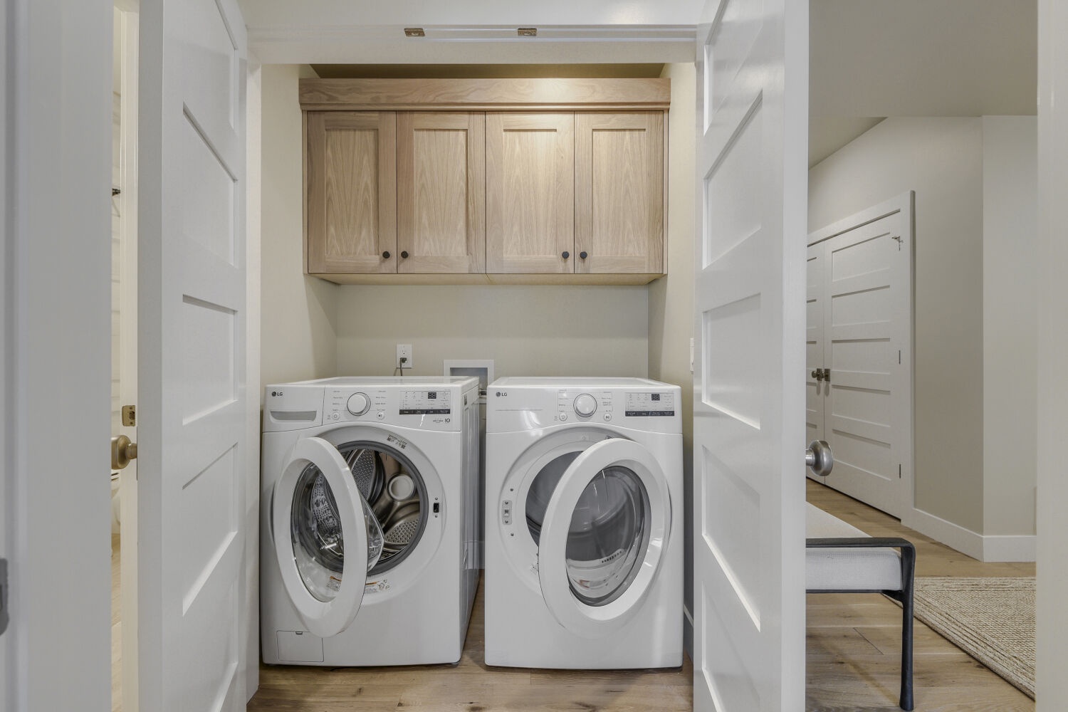 Your laundry needs are covered with convenient in-unit washer and dryer in this dedicated laundry room, complete with cabinet storage above.