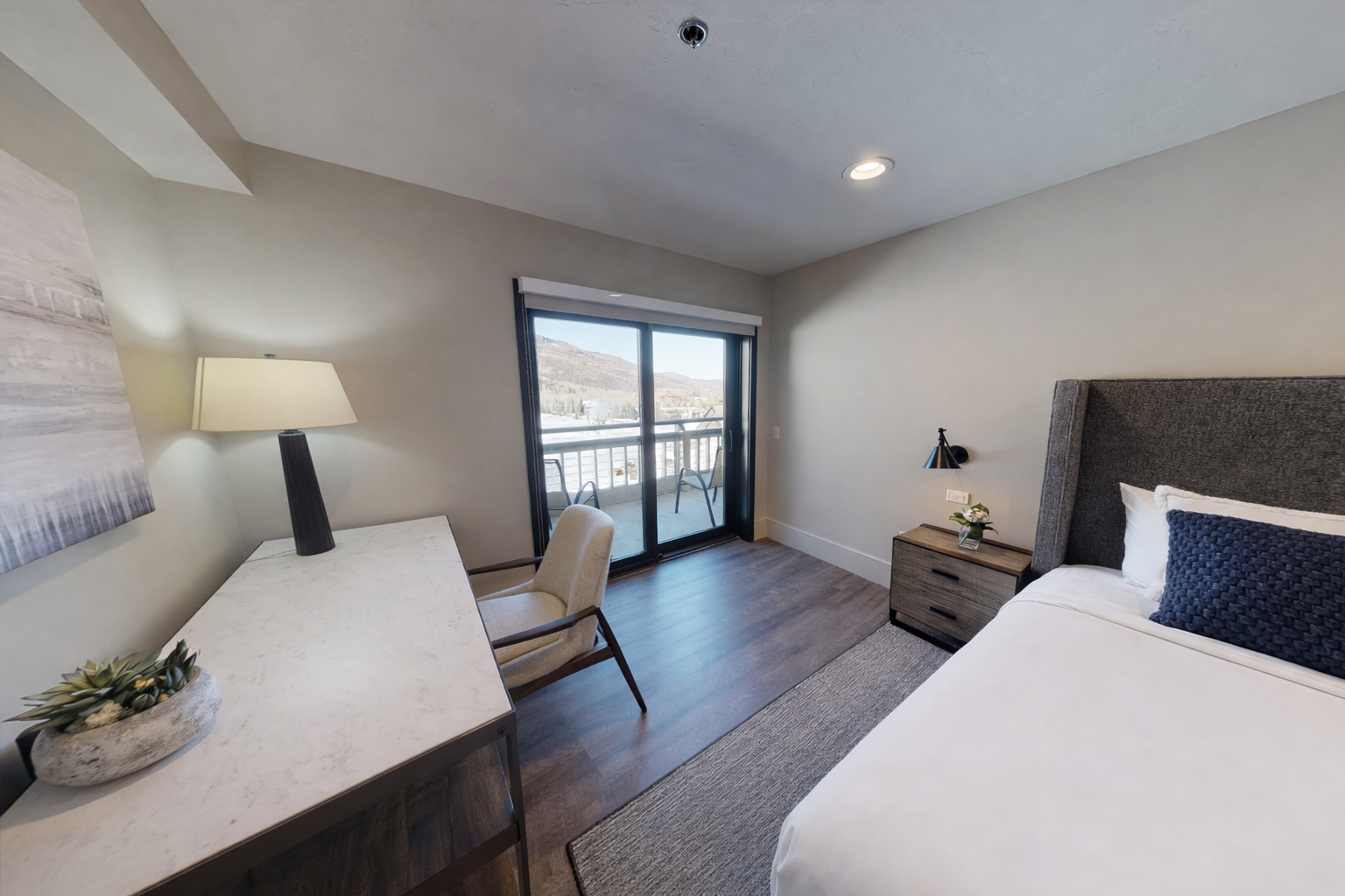 Relax in your modern bedroom with lake views from your private balcony, contemporary furnishings, and calming neutral tones.