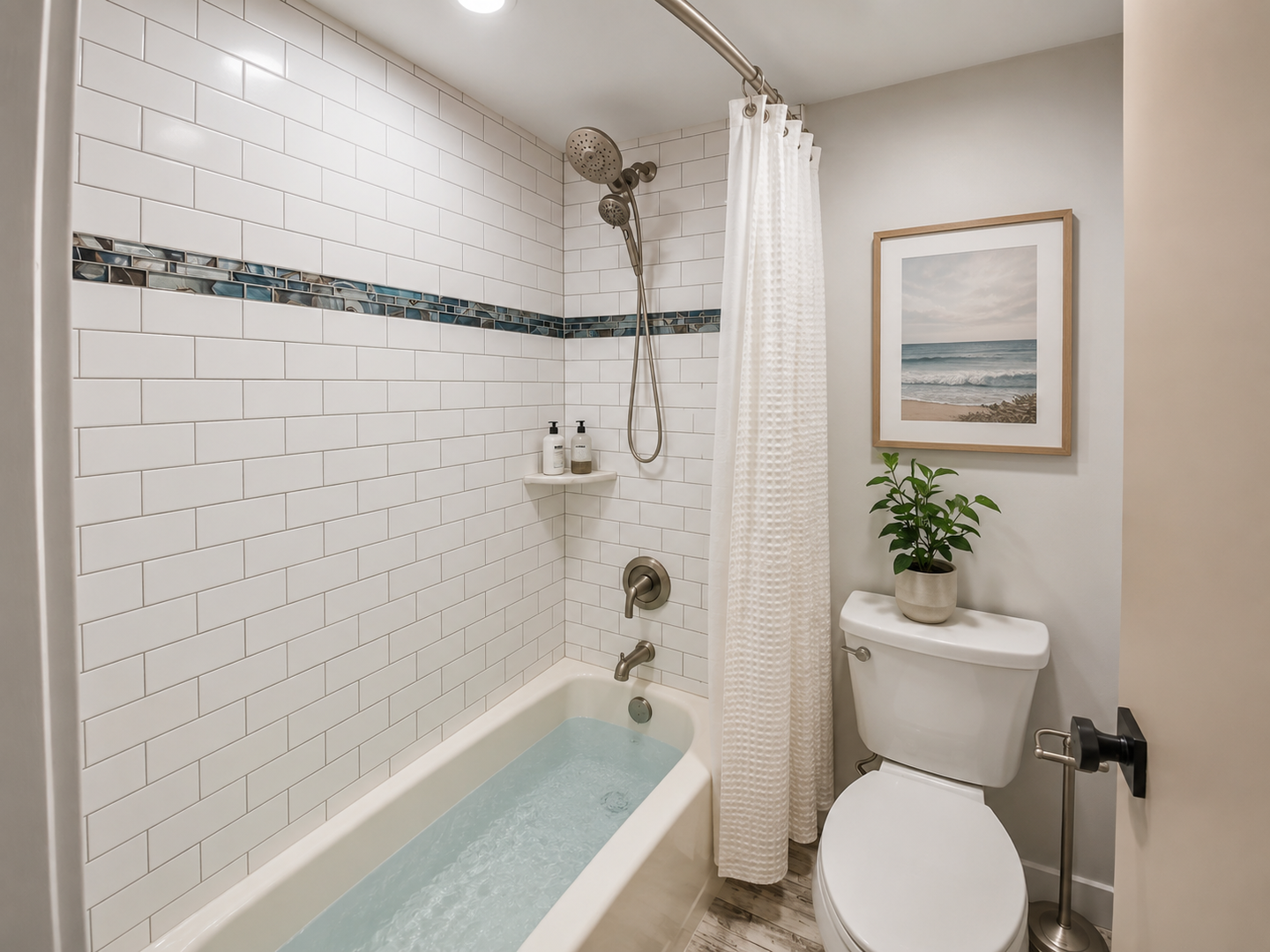Unwind in your private bathroom with a soothing soak in the tub, modern subway tile, and coastal-inspired art that brings the beach indoors.