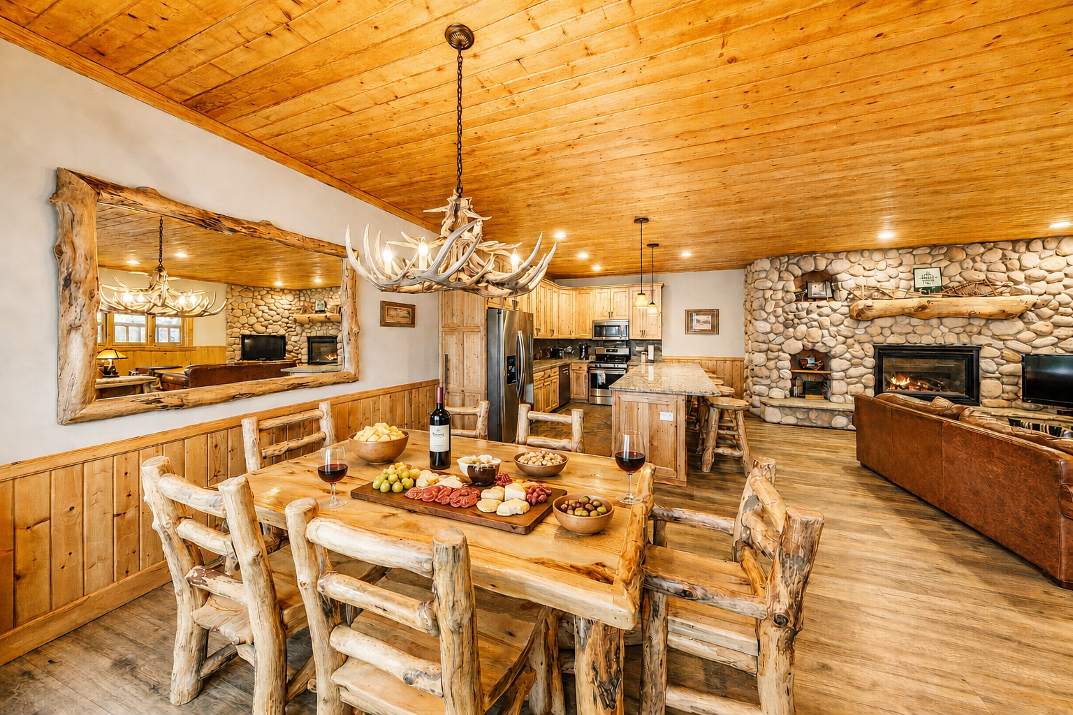 Gather around the rustic wood table under warm antler chandeliers, with the glow of the stone fireplace setting the perfect scene for your mountain getaway.