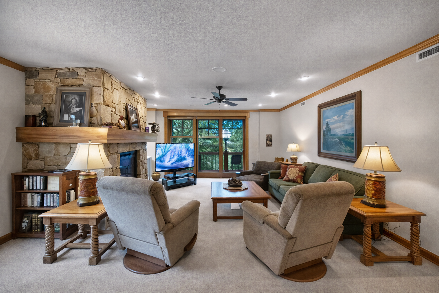 Cozy living room perfect for relaxing after the slopes. Enjoy the warm stone fireplace, comfy recliners, and TV. A true mountain retreat.