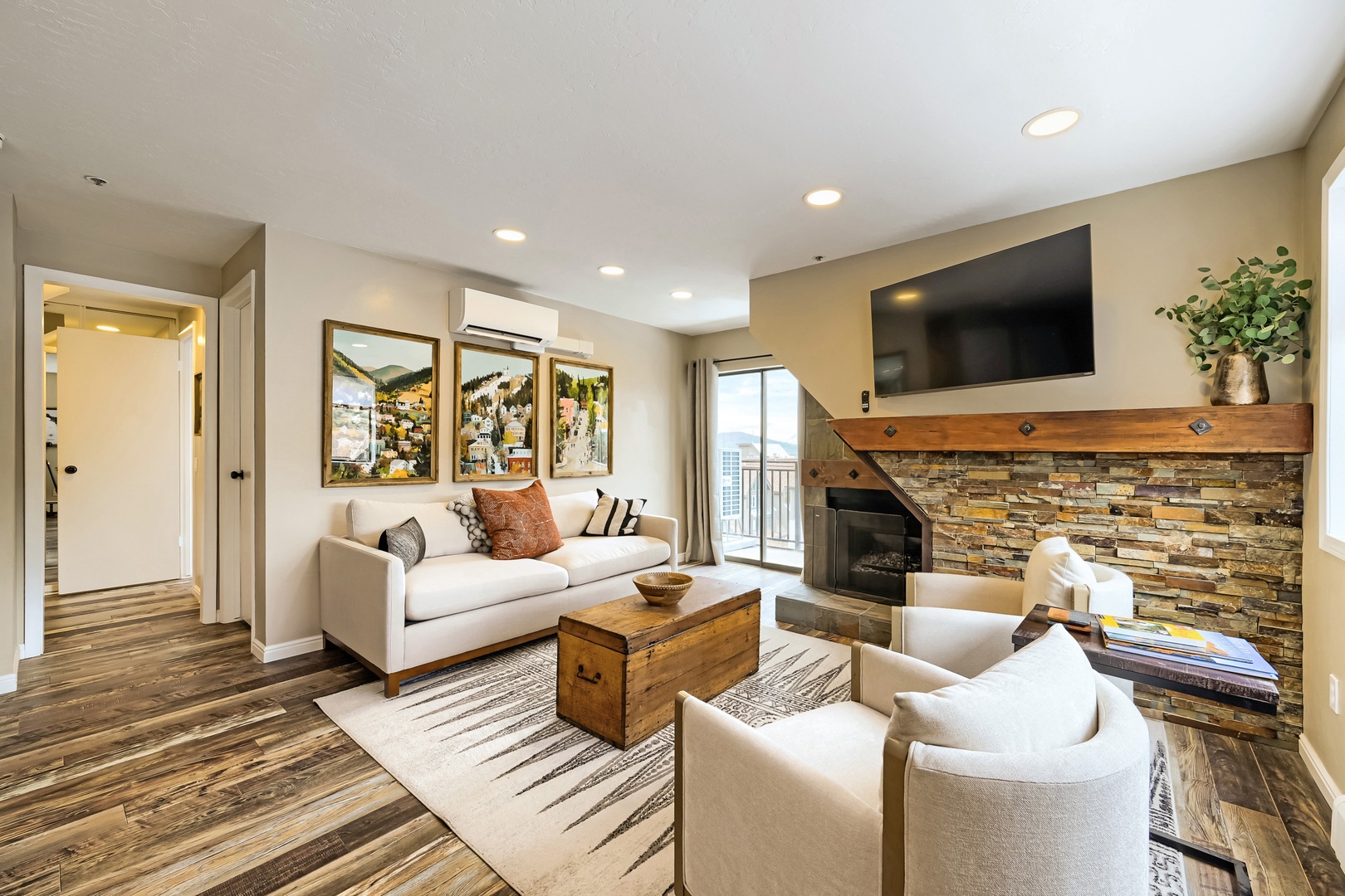 Unwind in your inviting living space with rustic charm, where a cozy fireplace and mountain-inspired décor create the perfect retreat after a day of adventure.
