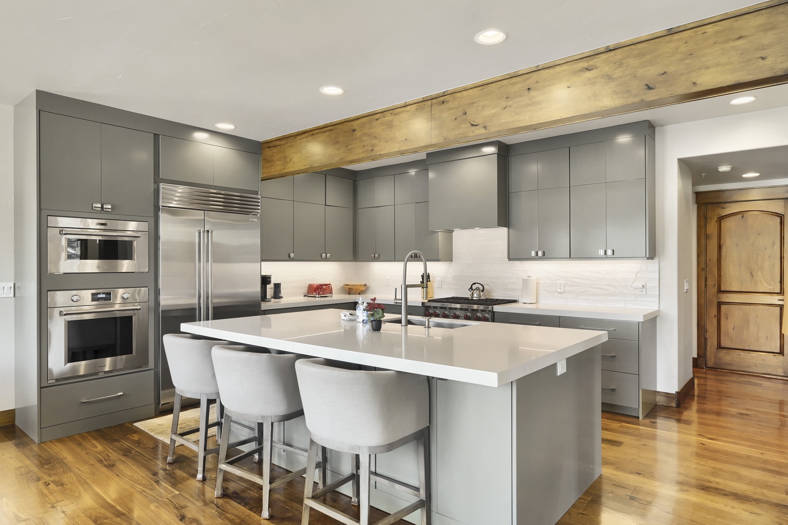 Your gourmet kitchen awaits with sleek modern cabinetry, stainless steel appliances, and a spacious island perfect for meal prep or casual dining with friends and family.