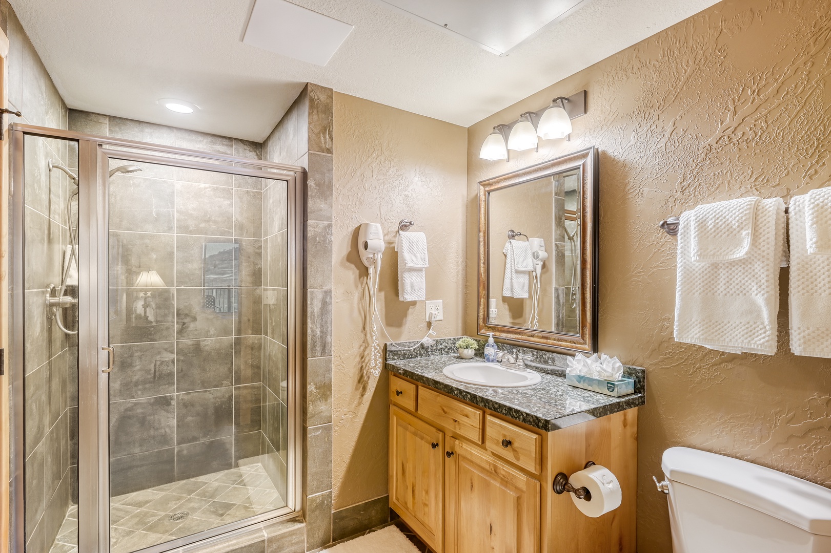 Unwind in your spacious bathroom with granite counters, walk-in shower, and plush towels waiting for you.