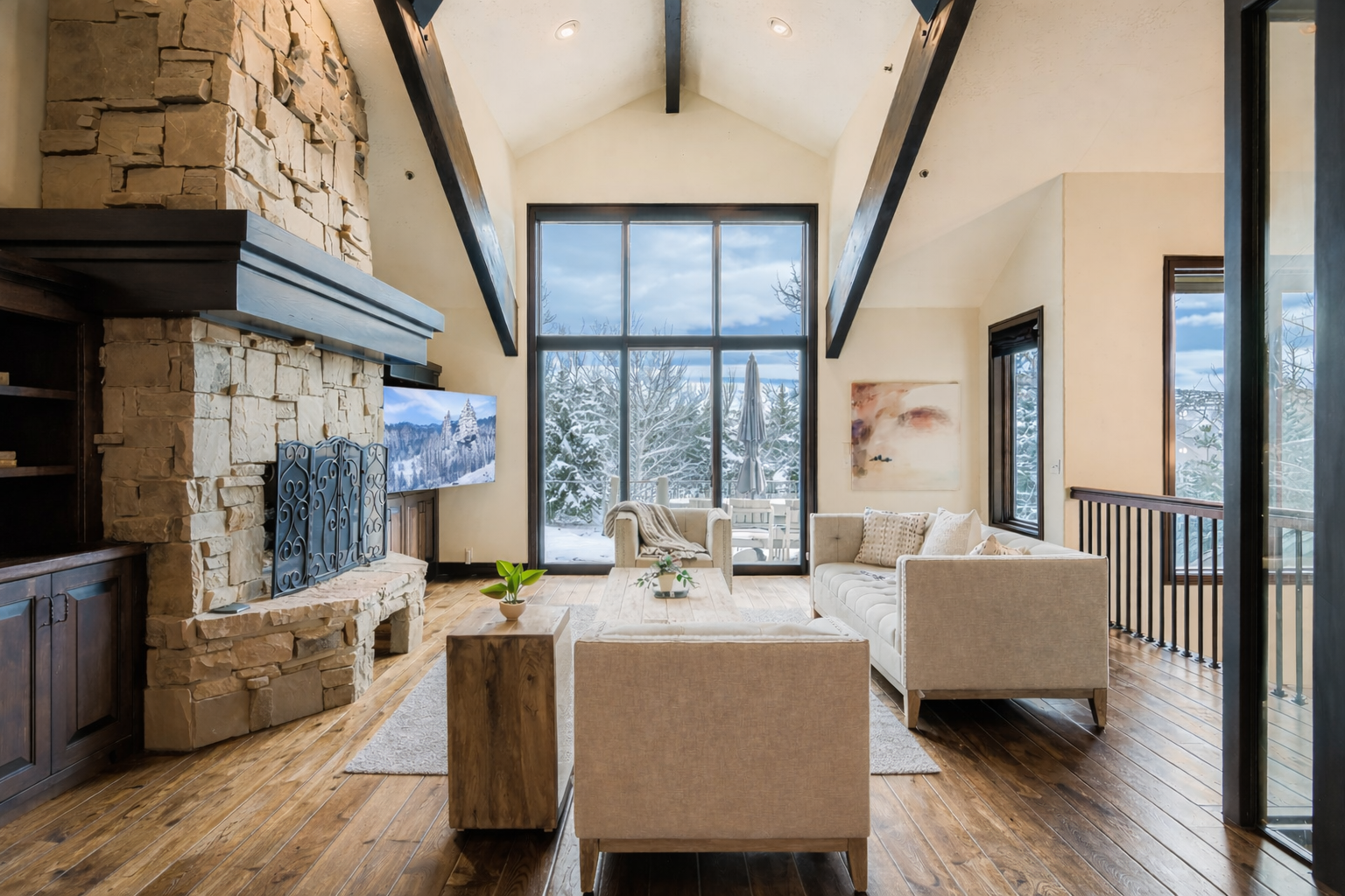 Cozy up by your stone fireplace while gazing at snow-dusted trees through floor-to-ceiling windows in this stunning mountain retreat.