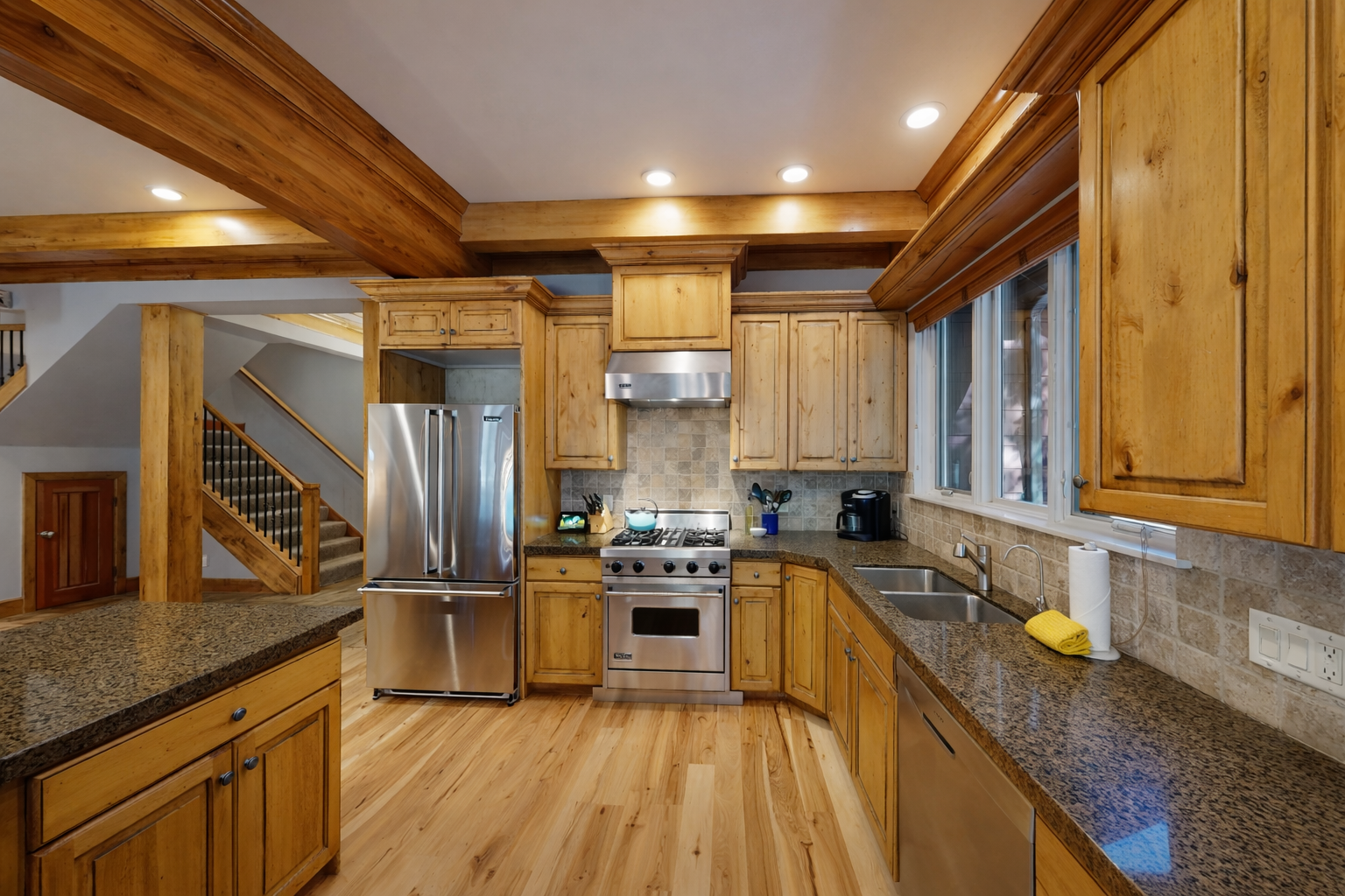 Your spacious kitchen features warm wood cabinetry, granite countertops, and stainless steel appliances for all your culinary adventures.