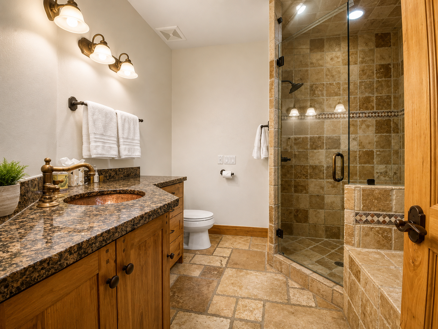 Unwind in your spa-like bathroom featuring a spacious walk-in shower, elegant granite vanity, and warm travertine tile throughout—your private retreat after a day of adventure.