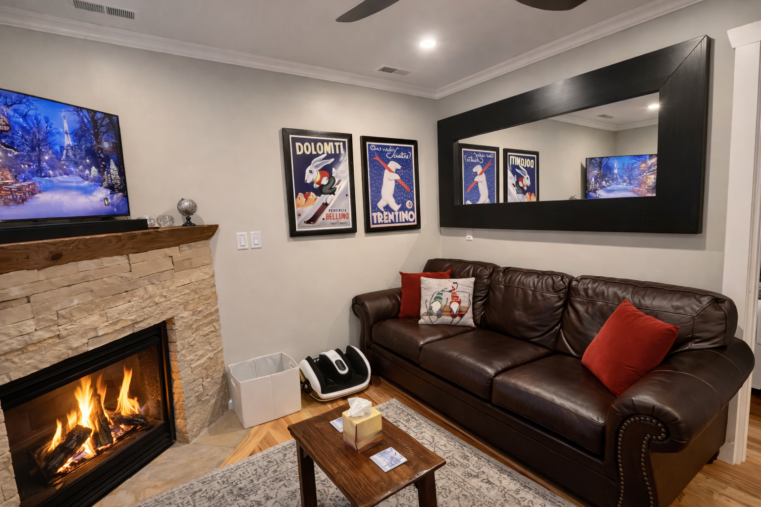 Unwind in the cozy living room with a stunning stone fireplace, large leather sectional sofa, and smart TV.