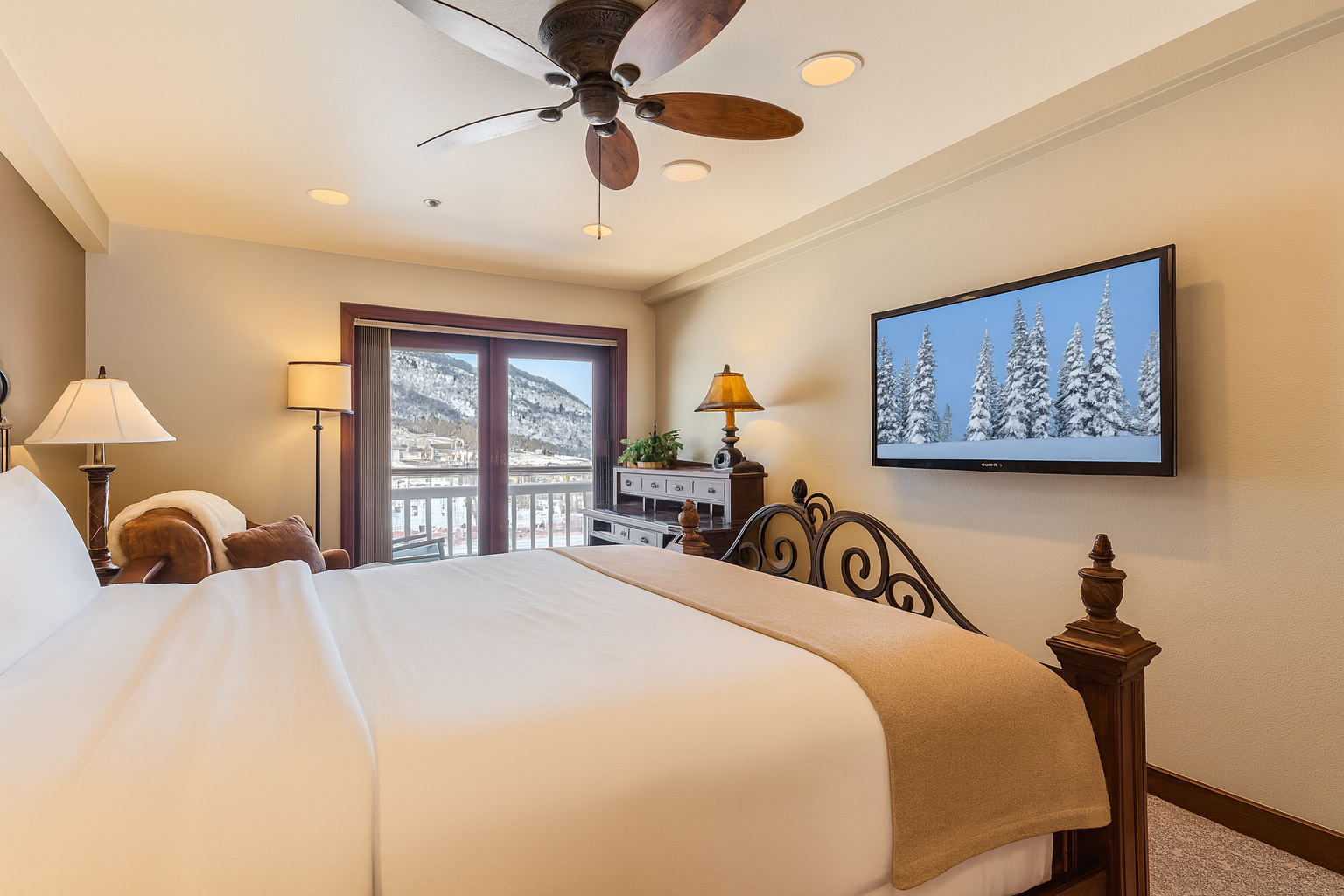 Unwind in your cozy bedroom featuring a plush king bed, mountain views from your private balcony, and a large flat-screen TV for your entertainment.