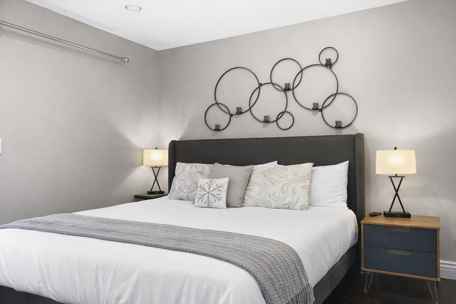 Your cozy bedroom opens to snowy mountain views through elegant French doors, creating the perfect winter retreat.