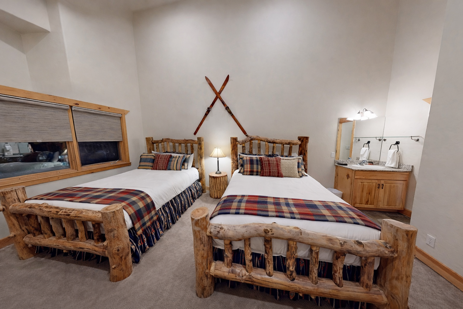 Cozy mountain lodge bedroom with handcrafted log beds and rustic charm for your alpine getaway.