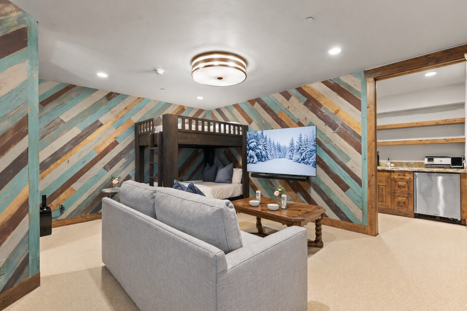 Unwind and sleep in this fun, dual-purpose room with a comfortable sofa, cozy bunk beds, and a stylish wood accent wall.