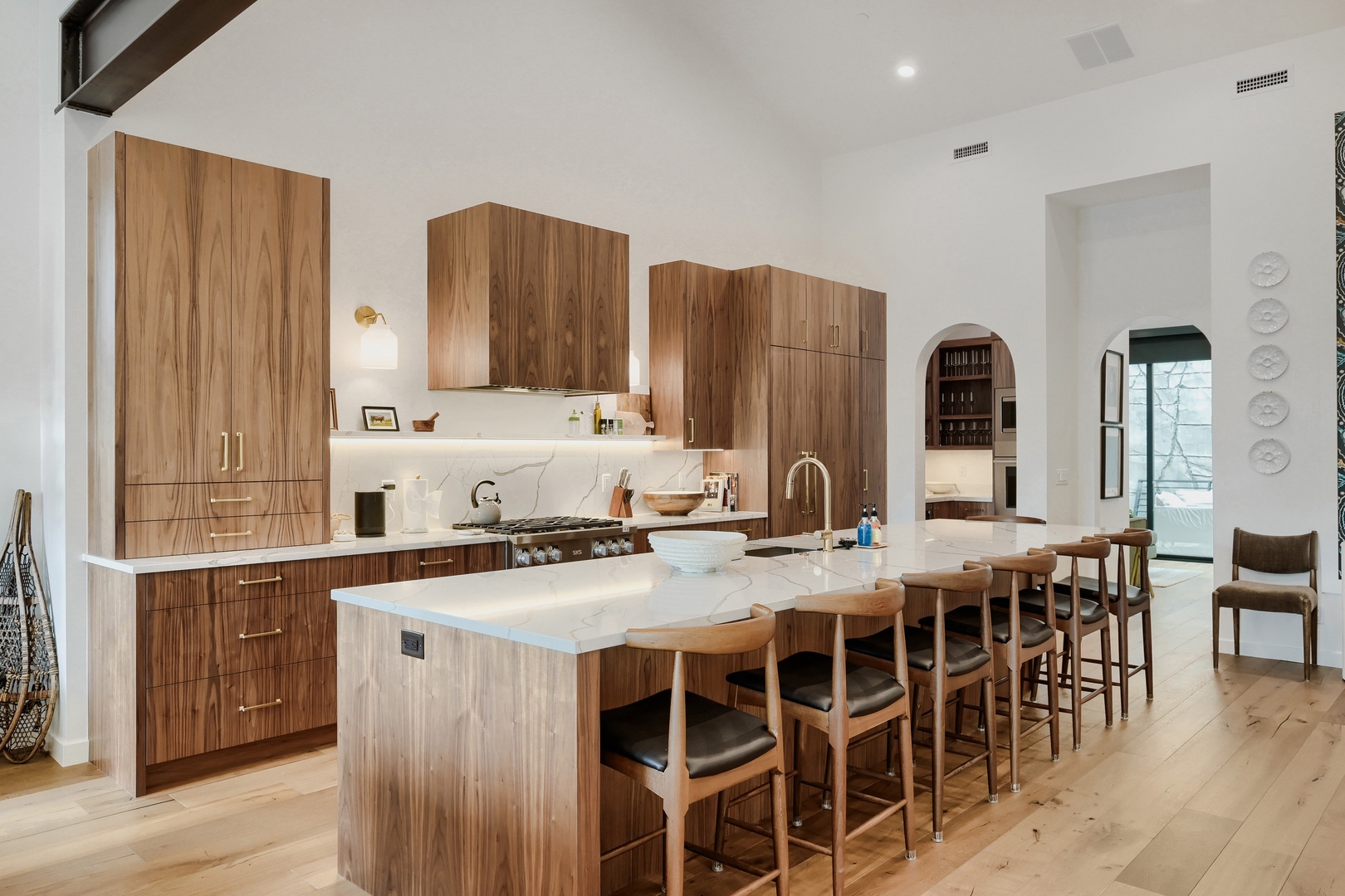 Step into your gourmet kitchen with rich walnut cabinetry, gleaming marble countertops, and a welcoming island where you can share meals and create memories together.