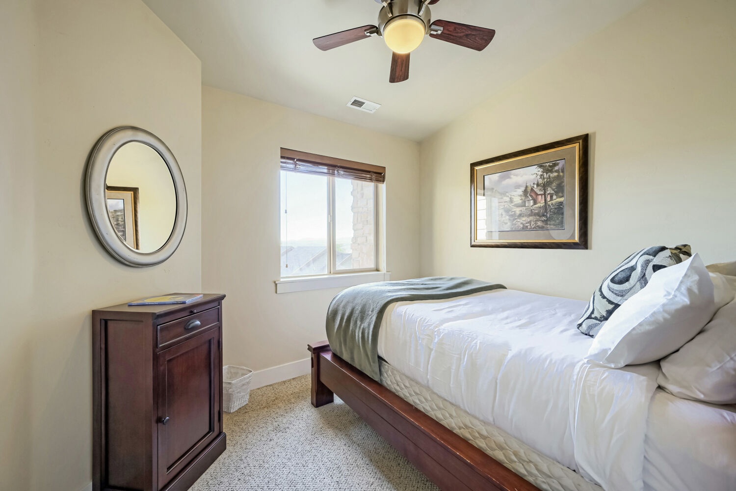 Slip into crisp linens and unwind beneath your own ceiling fan. Soft light fills your space, and a window invites natural views to brighten your mornings.