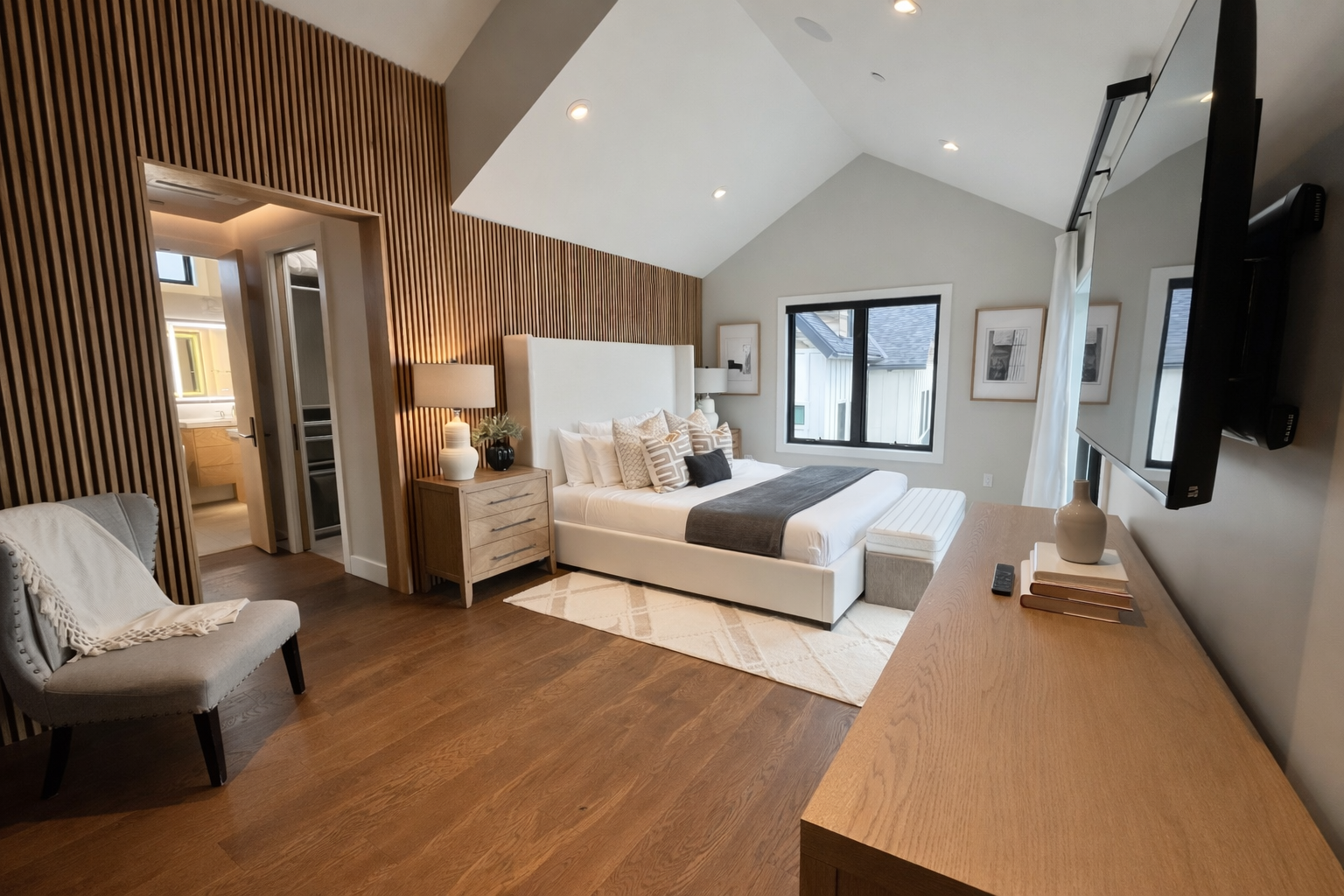 Your master bedroom sanctuary features rich wood tones and modern elegance, where you'll unwind beneath soaring ceilings with luxurious linens awaiting.