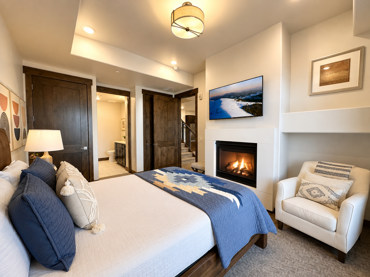 Settle into your cozy bedroom where a crackling fireplace and soft bedding invite you to unwind after a day exploring the area.