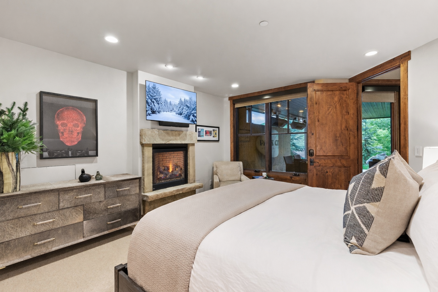 Cozy up in your luxurious bedroom with a crackling fireplace, flat-screen TV, and sliding doors to your private outdoor space.