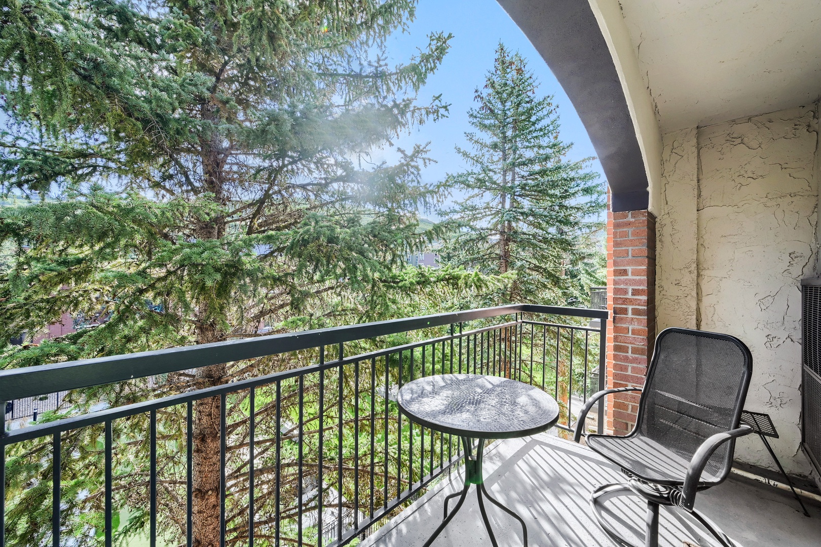 Step out onto your private balcony and breathe in the fresh mountain air. Tall pines frame your peaceful treetop view—the perfect spot to unwind with morning coffee or evening relaxation.