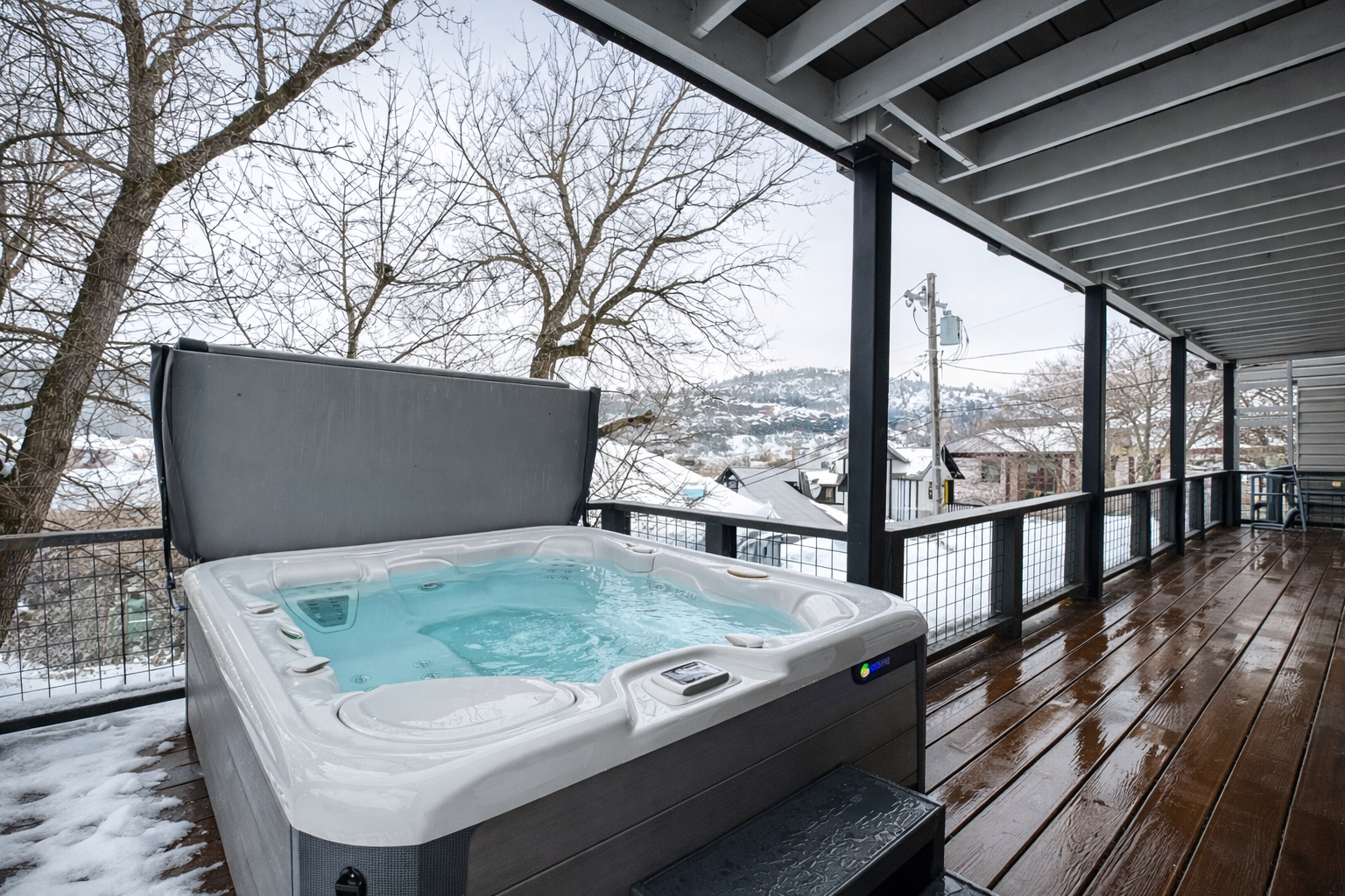 Soak away winter's chill in your private hot tub, where warm bubbles and snowy views create the perfect retreat.