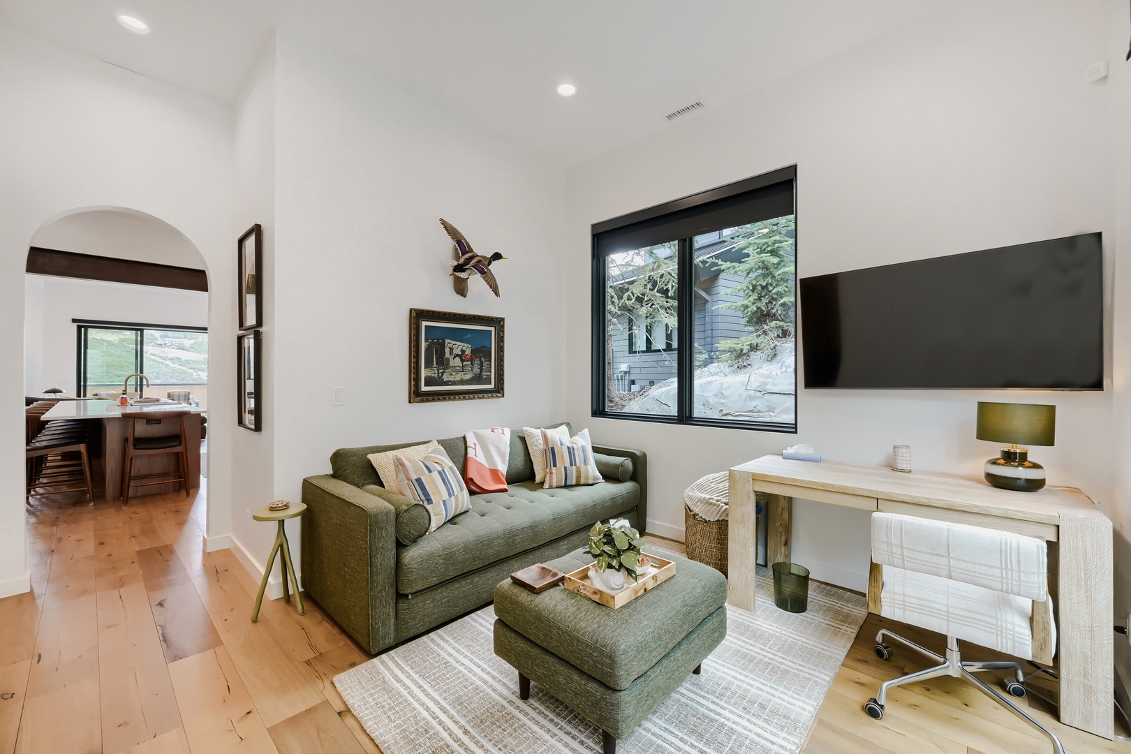 Settle into this bright living space where vaulted ceilings and natural light create an airy retreat. The comfortable sofa and thoughtful decor invite you to relax after a day exploring the mountains.