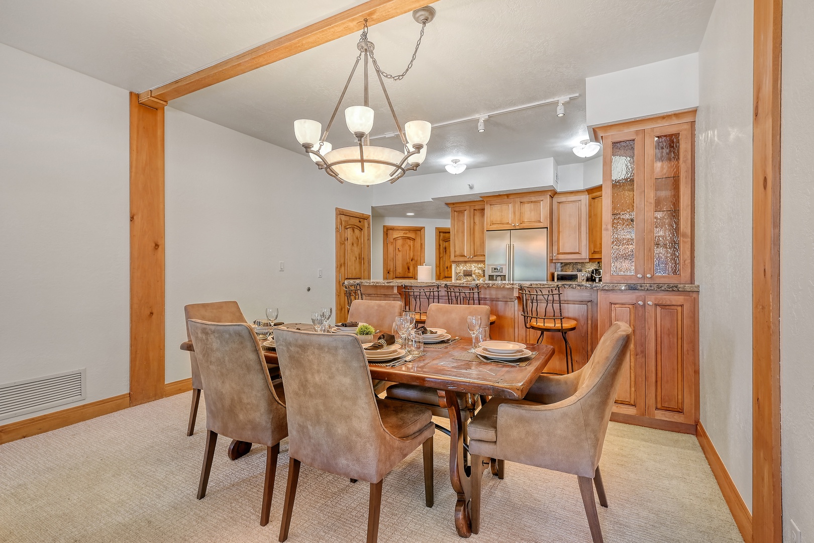 Your elegant dining space features warm wood accents and a stunning chandelier, perfect for memorable meals with loved ones.