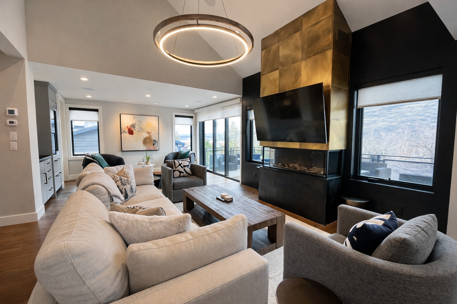 Unwind in this sophisticated living room where modern elegance meets mountain charm, complete with a cozy fireplace and stunning views.