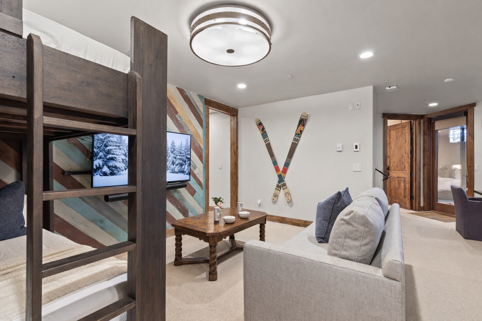 Unwind and sleep in this fun, dual-purpose room with a comfortable sofa, cozy bunk beds, and a stylish wood accent wall.