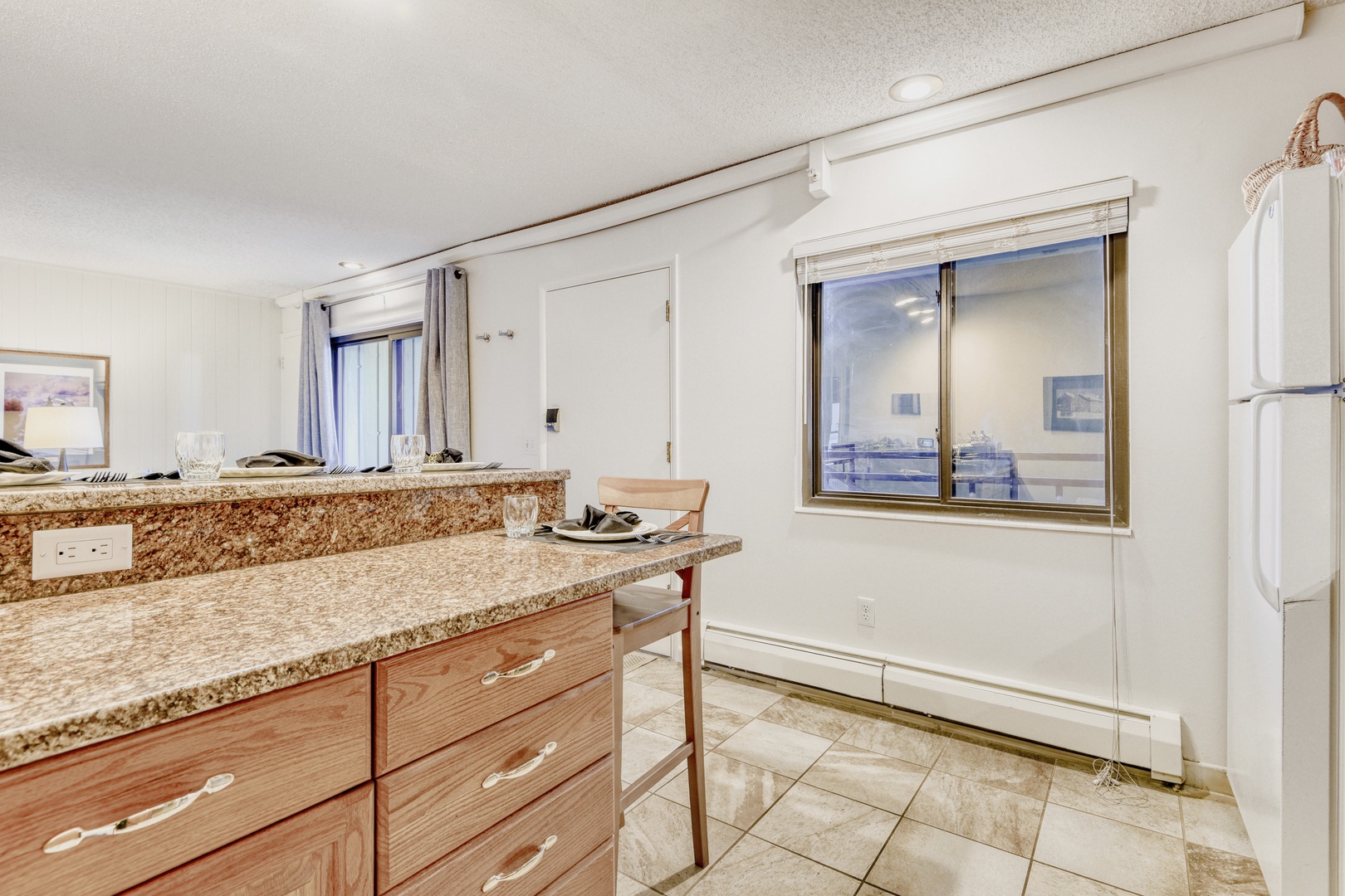 Your granite countertops and modern appliances make meal prep a joy with city views for inspiration.