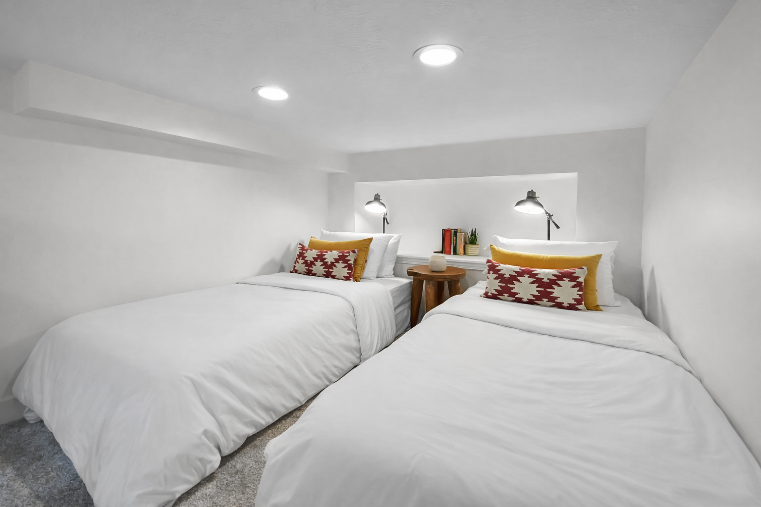 Your cozy sleeping space features modern bunk beds with plush bedding and warm orange accents for restful nights.