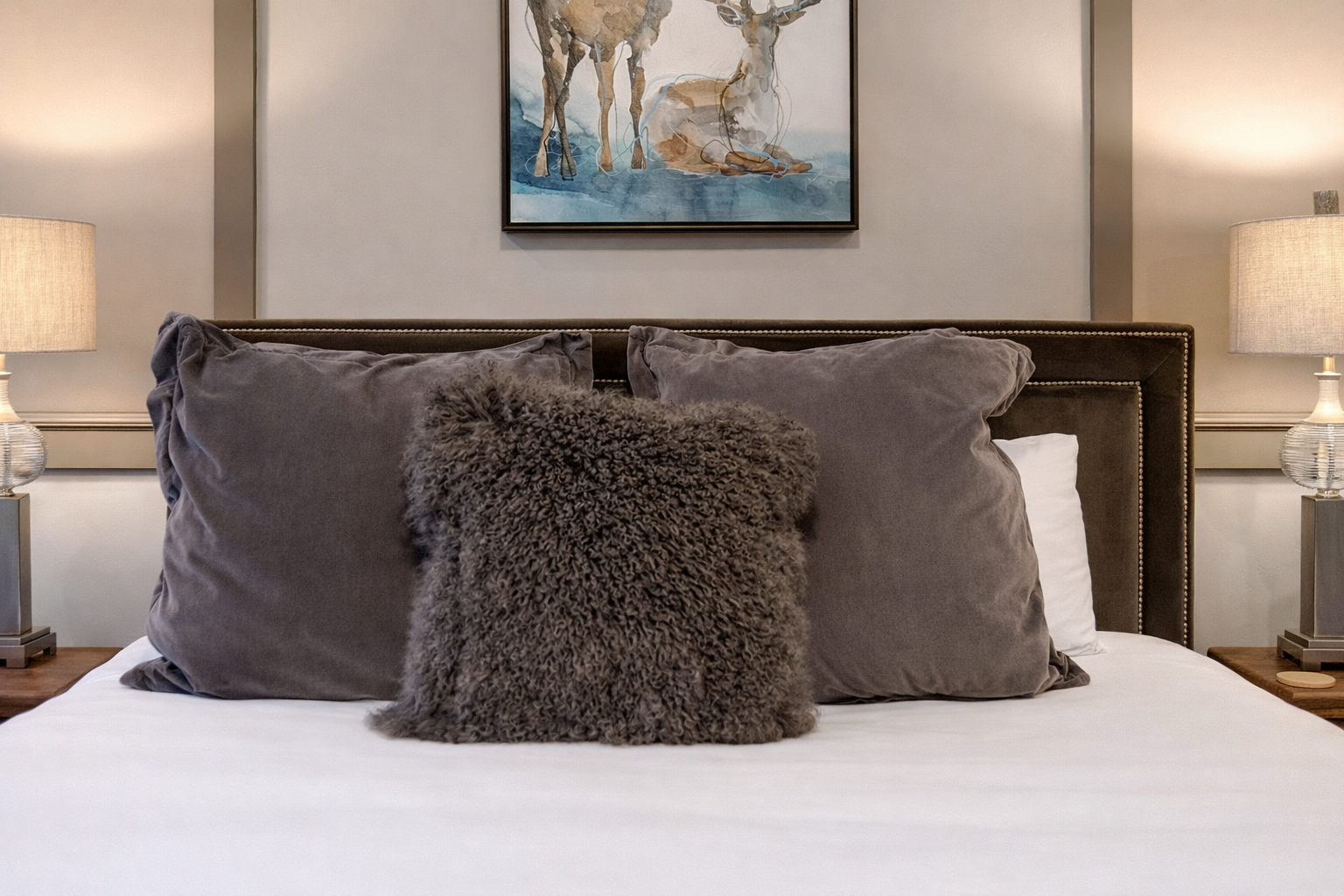 Unwind in your cozy bedroom with crisp linens, a warming fireplace, and modern amenities creating the perfect retreat after mountain adventures.