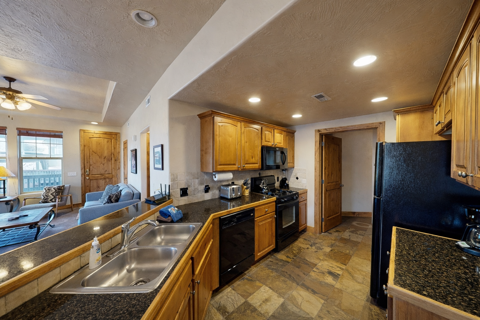 Your fully equipped kitchen features granite counters, stainless appliances, and warm wood cabinets for memorable meal preparation.
