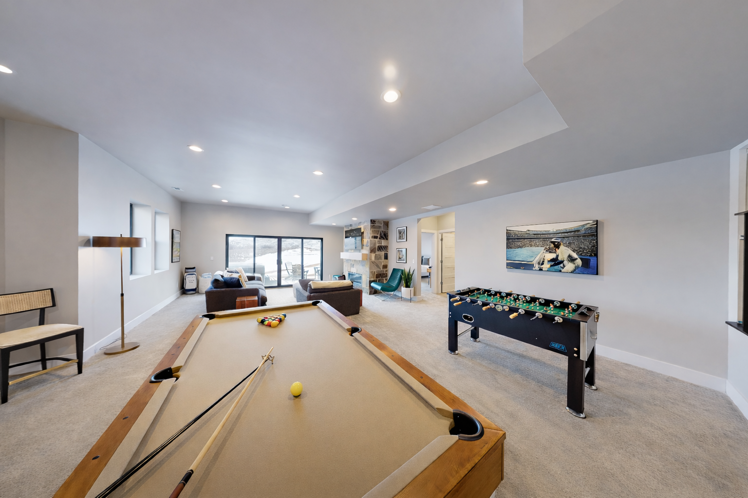 Your private game room awaits with premium pool table and foosball, perfect for entertaining friends in this bright, modern space.