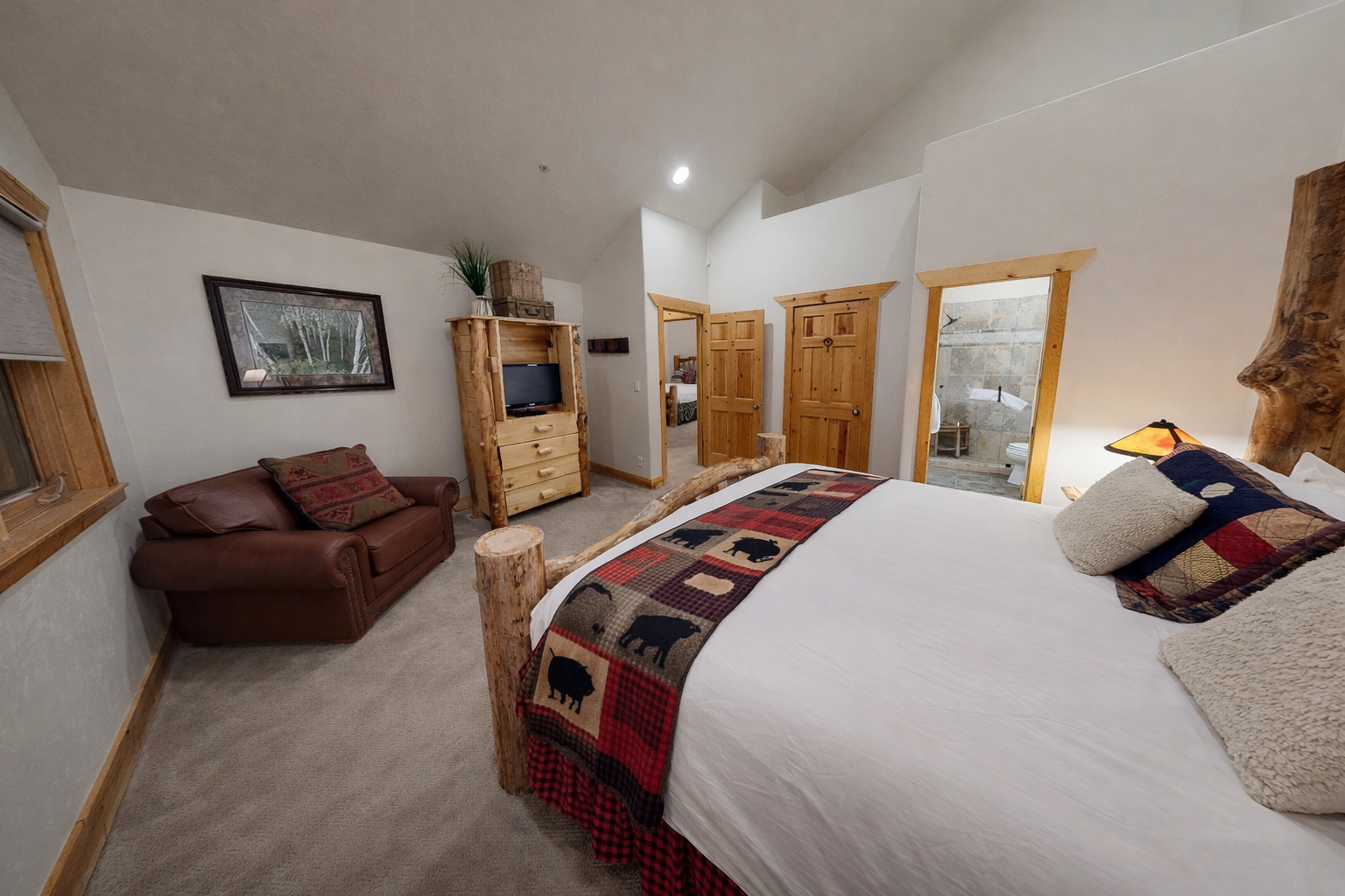 Unwind in your rustic bedroom featuring a cozy seating area and charming lodge-style decor that makes you feel at home.