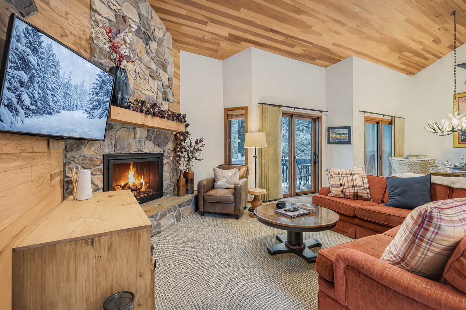 Curl up by your crackling fireplace in this cozy mountain retreat, where warm wood accents and comfortable seating create the perfect après-ski atmosphere.