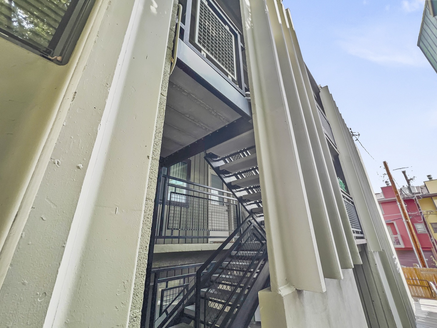 Modern, well-lit exterior stairway with sturdy metal railings and easy access to the unit. Offers convenience and safety for guests seeking a comfortable, well-maintained Park City vacation rental.