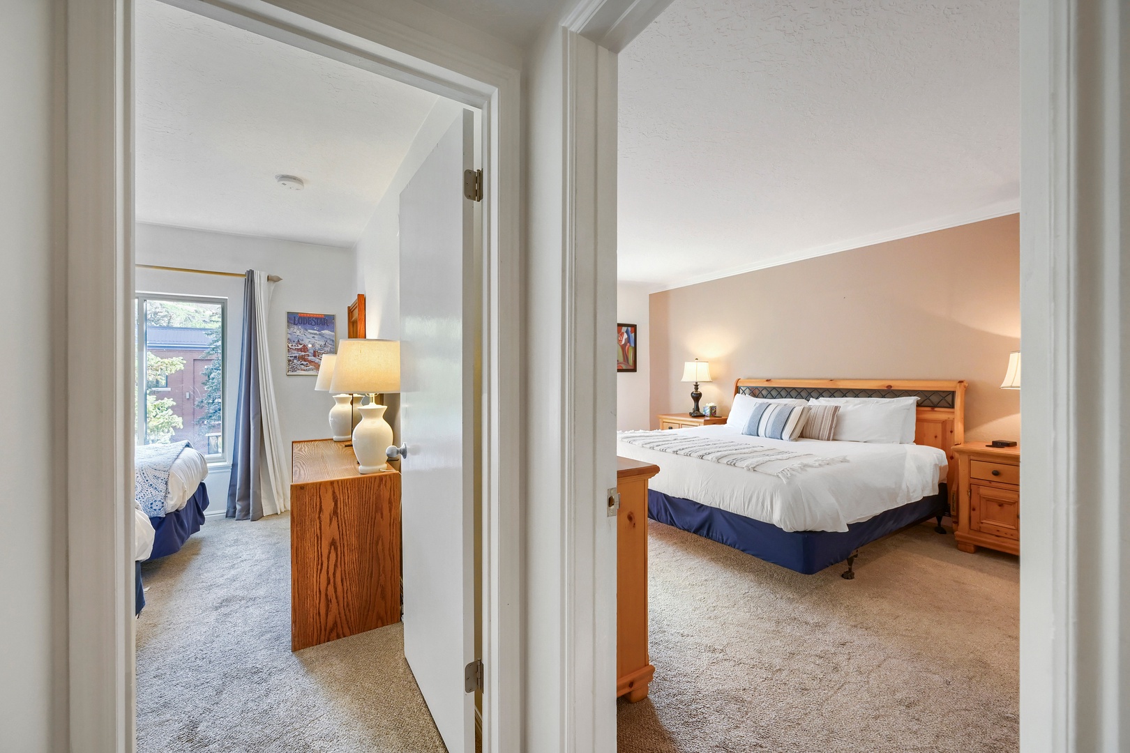 Two inviting bedrooms await, each with soft carpeting and warm wood furnishings. Sink into crisp linens and let the peaceful ambiance help you unwind after a day of adventure.