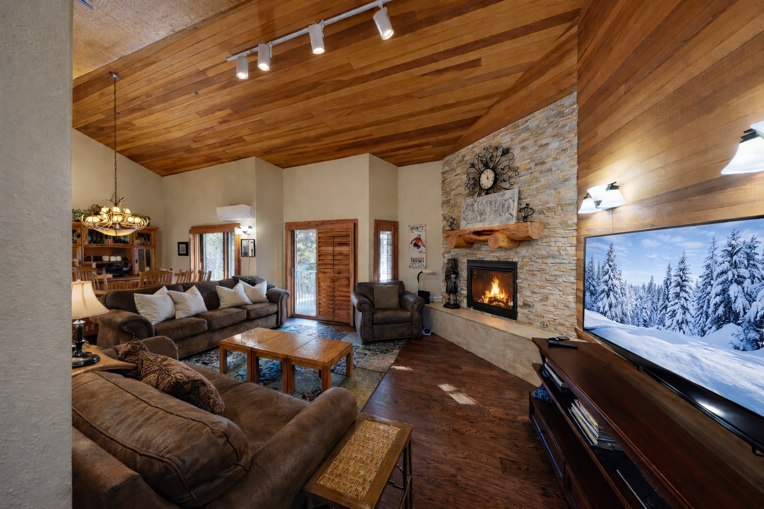 Cozy up in your rustic living room with warm wood beams, crackling fireplace, and plush seating perfect for mountain evenings.