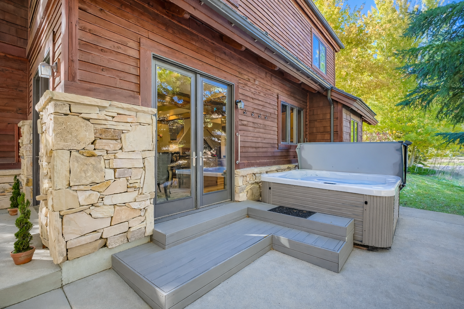 Soak your worries away in your private hot tub, surrounded by beautiful stone accents and peaceful mountain views.