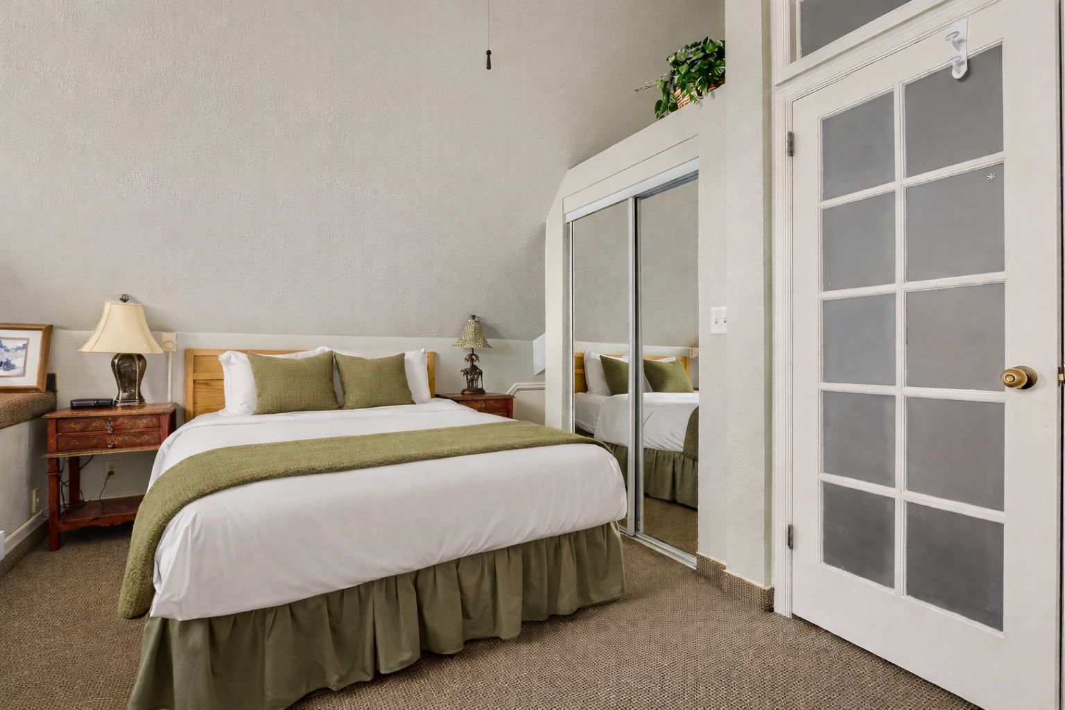 Cozy loft bedroom with a comfortable bed, ceiling fan, and unique sitting area. A tranquil mountain retreat for a restful stay in Park City.
