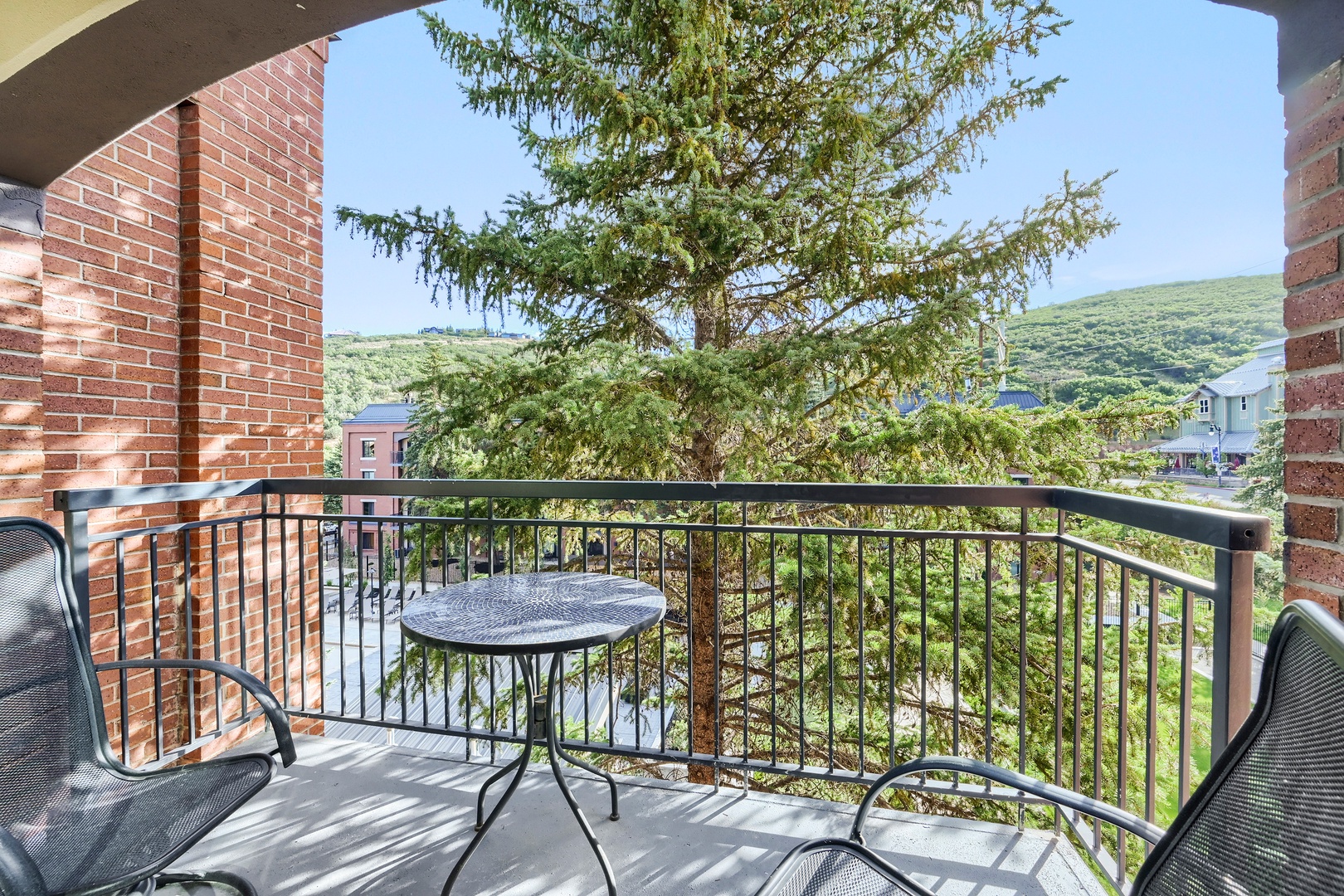 Step onto your private balcony and breathe in the fresh mountain air. Sip morning coffee at the bistro table while gazing at lush hillsides and nearby homes nestled among evergreens.