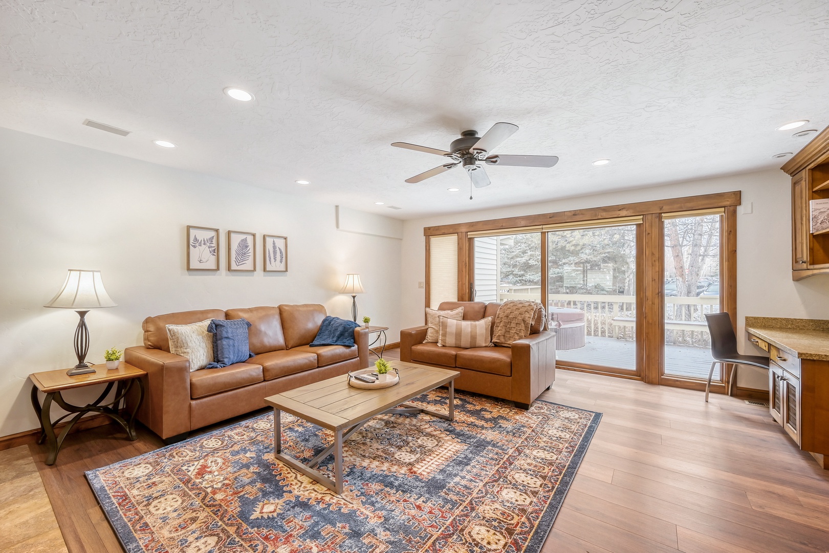 Unwind in your cozy living room where warm leather seating and rich hardwood floors create the perfect retreat after exploring.