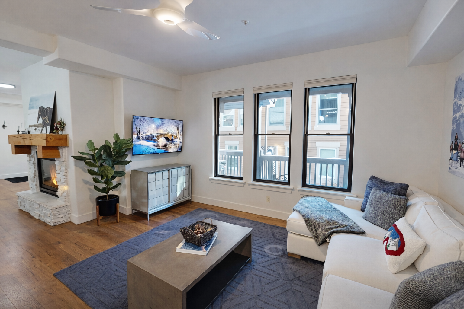 Relax in your stylish living room with cozy seating, modern fireplace, and large windows that fill the space with natural light.