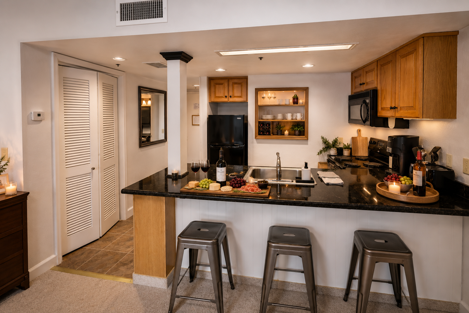 Your fully equipped kitchen features elegant black granite countertops, modern appliances, and a breakfast bar perfect for casual meals or entertaining guests with wine and appetizers.
