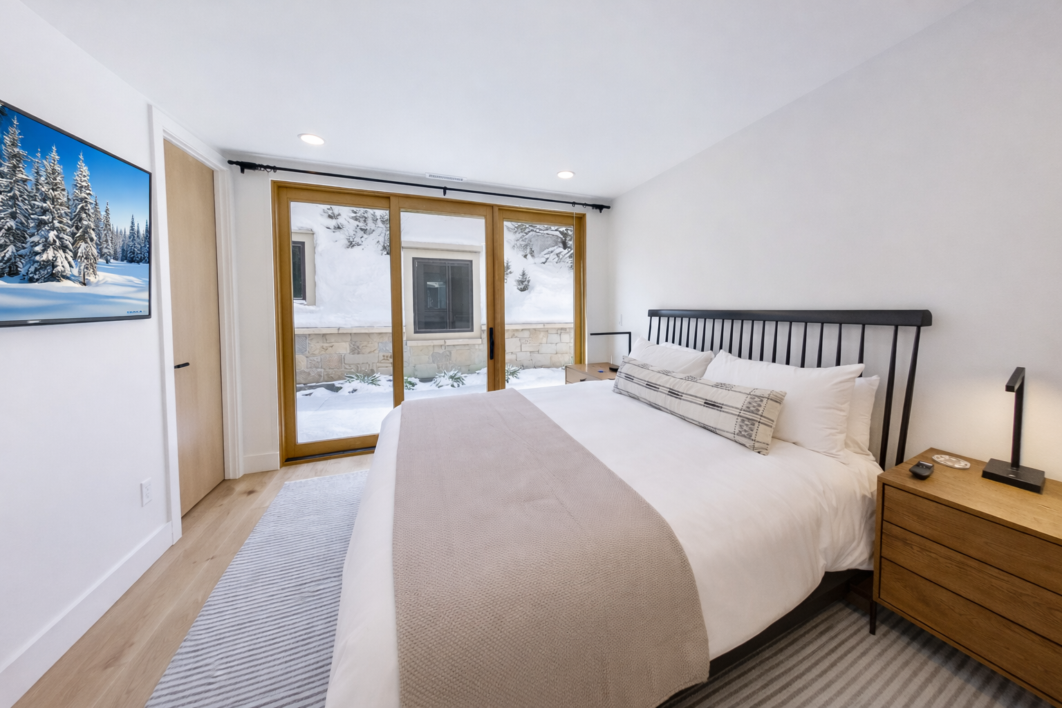 Retreat to the stylish master suite featuring a large king-size bed, natural light, and modern decor.