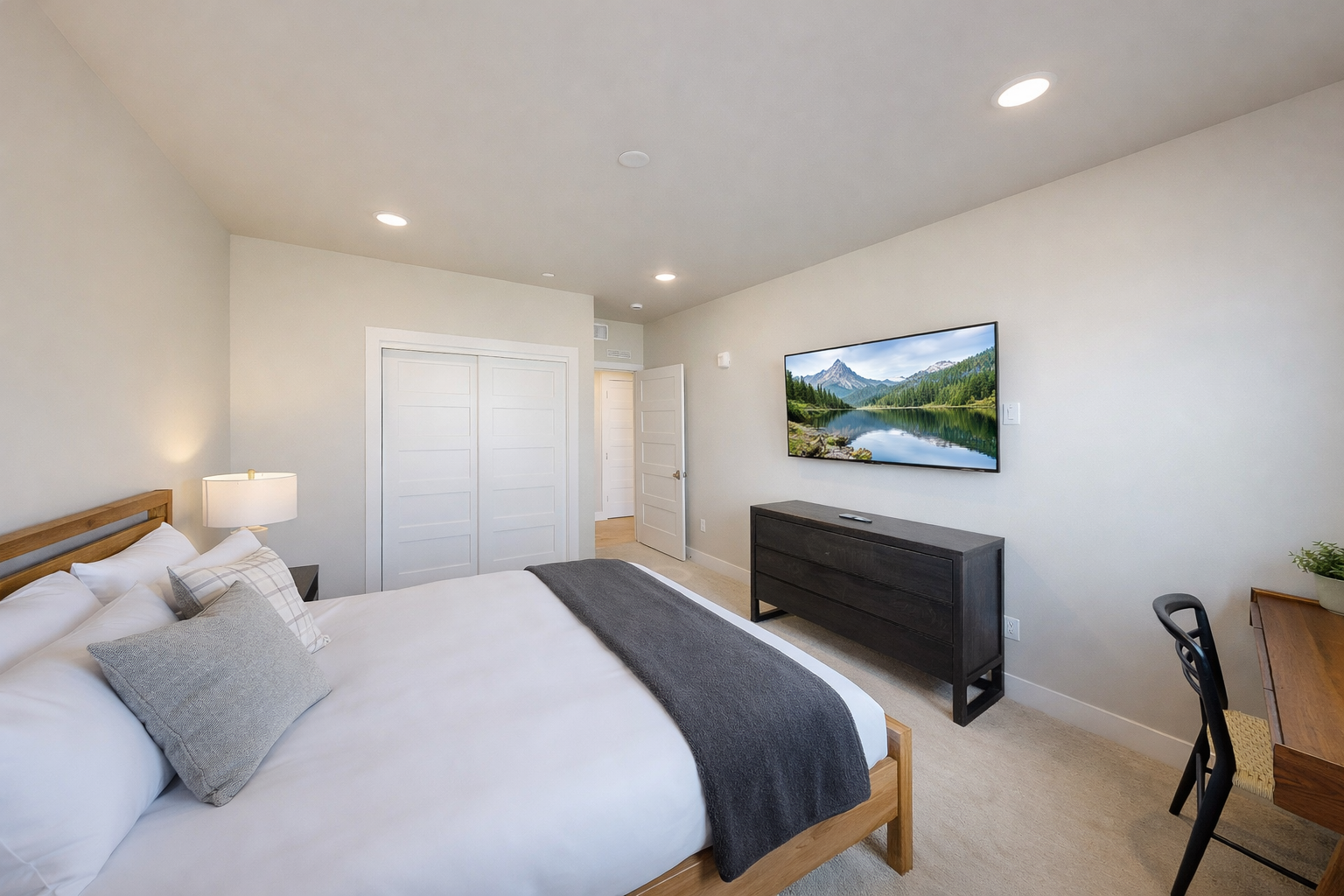 Unwind in your serene bedroom featuring a cozy bed, modern entertainment center, and thoughtful lighting for the perfect evening retreat.