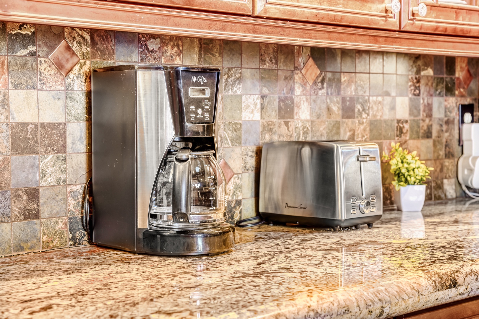 Wake up to fresh coffee brewing in your fully equipped kitchen, complete with premium appliances and elegant granite countertops.